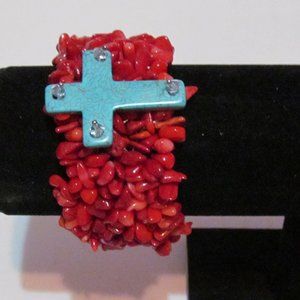 Woman's coral howlite chips blue cross stretch bracelet